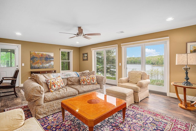 7431 W Buchanan Rd, Shelby, MI 49455 - living room featuring baseboards, wood finished floors, ceiling fan, a water view, and recessed lighting