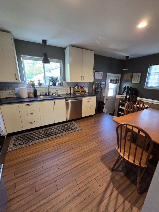 5966 Engleman Ave, Warren, MI 48091 - kitchen with dishwasher, dark countertops, dark wood-type flooring, decorative backsplash, and a sink
