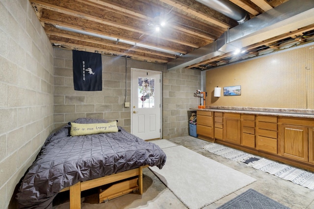 1548 Indian Trl, Pleasant Lake, MI 49272 - bedroom with concrete floors and concrete block wall
