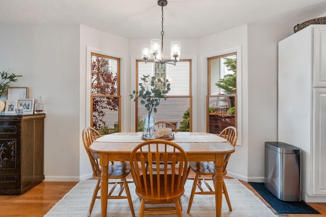 1548 Indian Trl, Pleasant Lake, MI 49272 - dining space featuring a chandelier, light wood finished floors, and baseboards