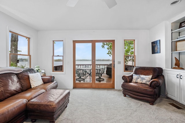 1548 Indian Trl, Pleasant Lake, MI 49272 - carpeted living area with a ceiling fan, a water view, and baseboards