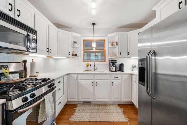 1548 Indian Trl, Pleasant Lake, MI 49272 - kitchen with stainless steel appliances, open shelves, a sink, and white cabinets