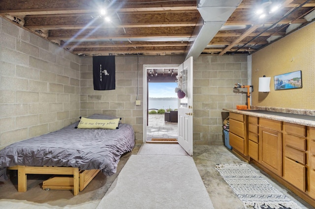 1548 Indian Trl, Pleasant Lake, MI 49272 - bedroom featuring unfinished concrete floors and access to exterior