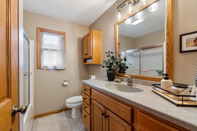 1548 Indian Trl, Pleasant Lake, MI 49272 - bathroom featuring toilet, vanity, tile patterned flooring, baseboards, and enclosed tub / shower combo