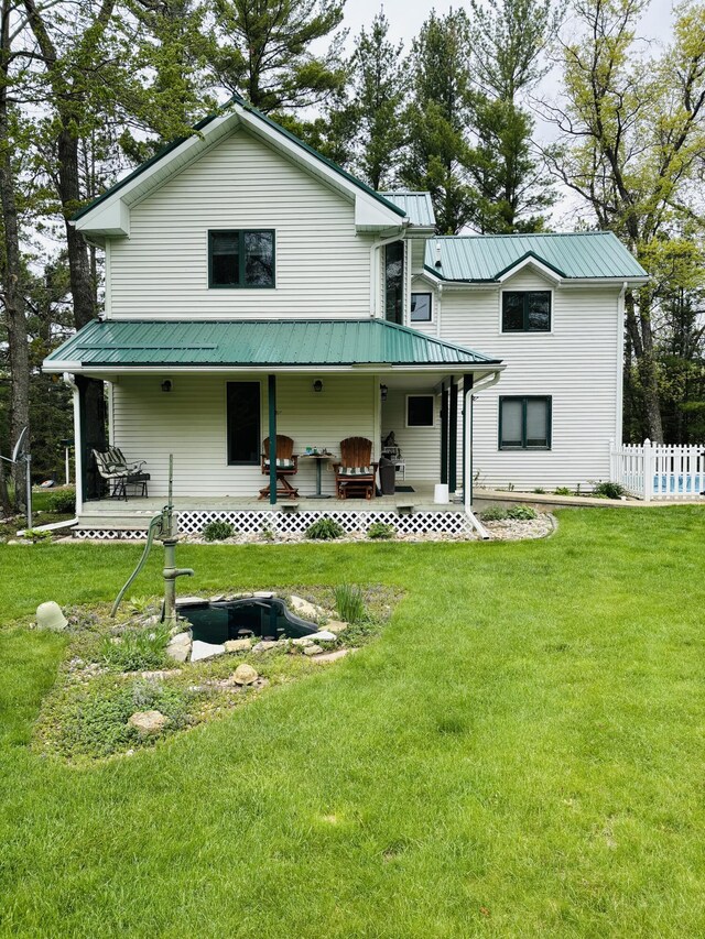 4375 W Haskell Lake Rd, Harrison, MI 48625 - rear view of house with a metal roof