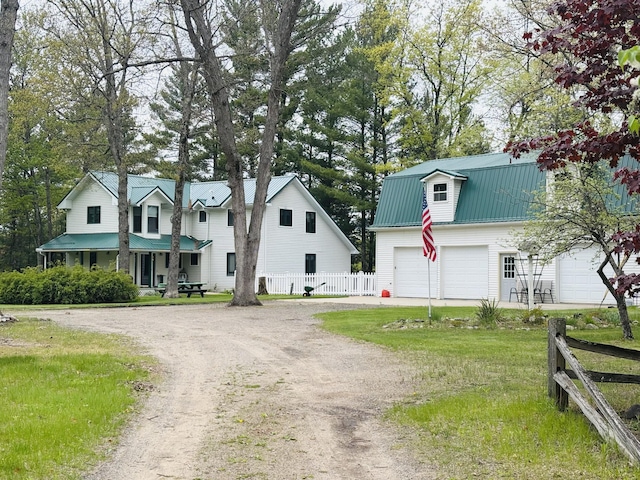 4375 W Haskell Lake Rd, Harrison, MI 48625 - dutch colonial featuring dirt driveway, a metal roof, and a garage