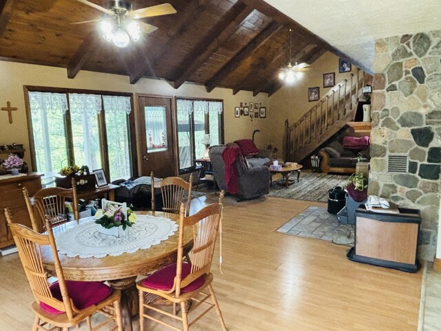 4375 W Haskell Lake Rd, Harrison, MI 48625 - dining space with ceiling fan, wood finished floors, stairs, and wood ceiling