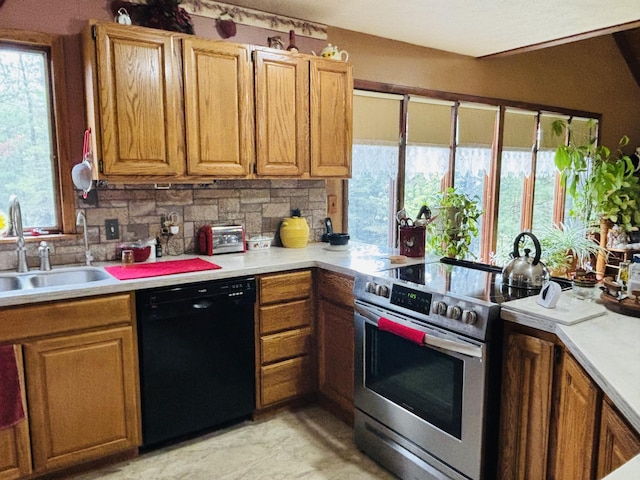 4375 W Haskell Lake Rd, Harrison, MI 48625 - kitchen with black dishwasher, stainless steel electric stove, light countertops, brown cabinets, and tasteful backsplash