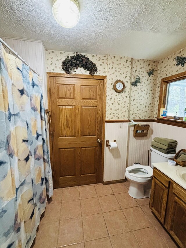 4375 W Haskell Lake Rd, Harrison, MI 48625 - full bathroom featuring wallpapered walls, a wainscoted wall, a textured ceiling, vanity, and tile patterned floors