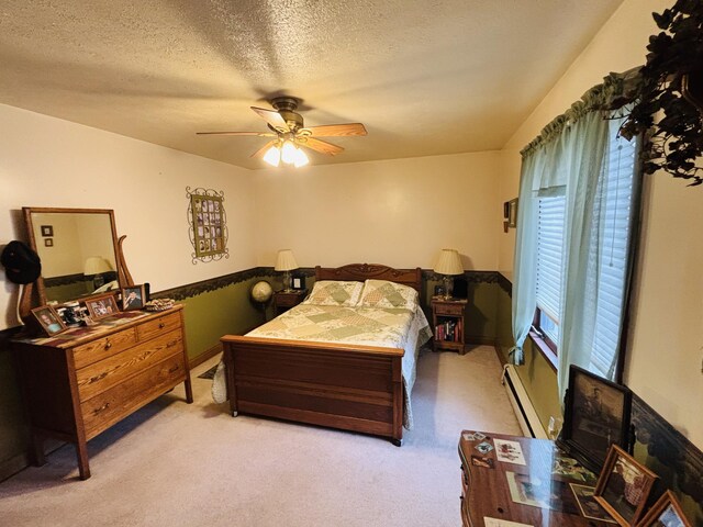 4375 W Haskell Lake Rd, Harrison, MI 48625 - bedroom featuring a baseboard radiator, light carpet, a textured ceiling, and ceiling fan