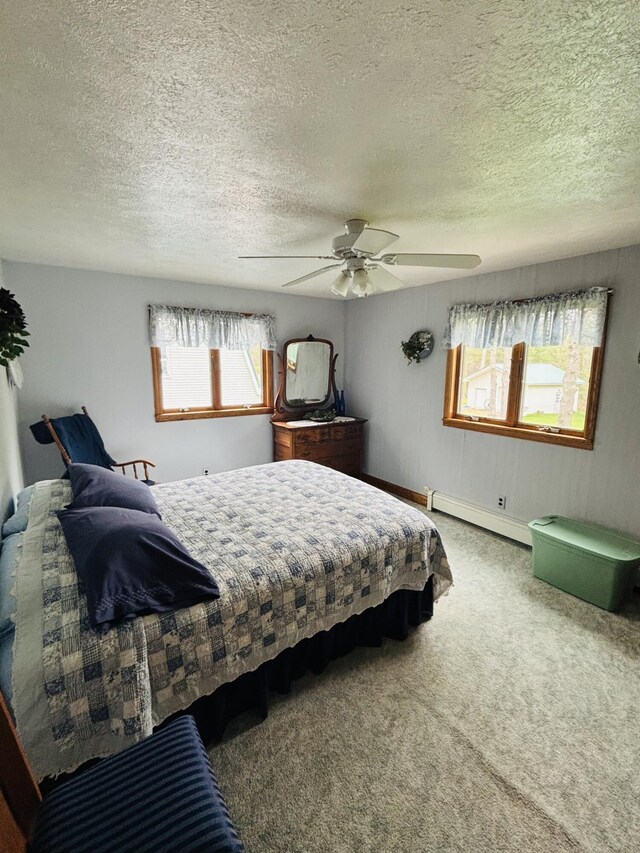 4375 W Haskell Lake Rd, Harrison, MI 48625 - bedroom featuring baseboard heating, carpet flooring, a textured ceiling, and a ceiling fan