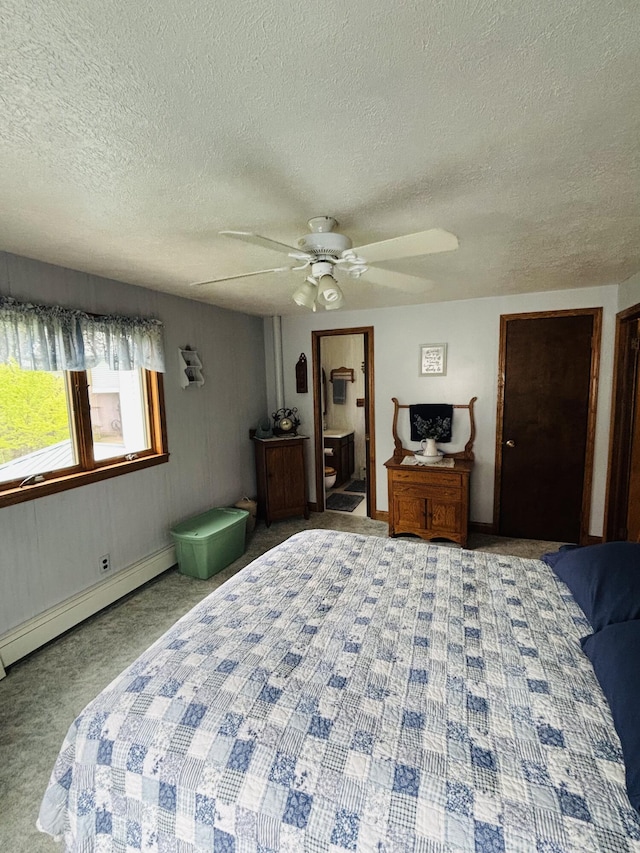 4375 W Haskell Lake Rd, Harrison, MI 48625 - carpeted bedroom with baseboard heating, a textured ceiling, ceiling fan, and connected bathroom
