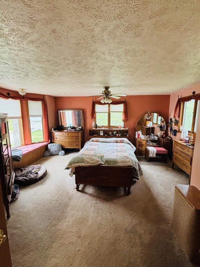4375 W Haskell Lake Rd, Harrison, MI 48625 - carpeted bedroom featuring a textured ceiling, multiple windows, and ceiling fan
