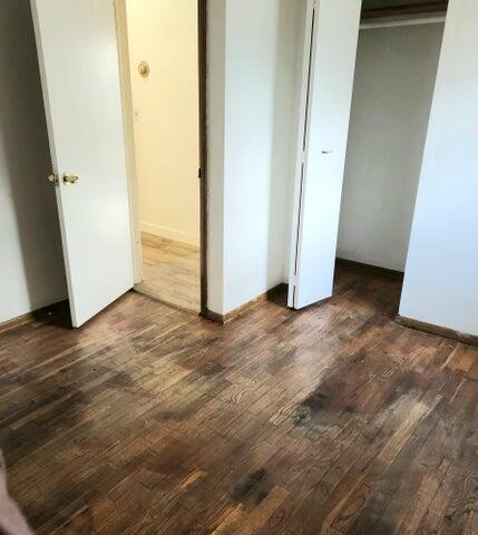 5678 Leona Ave, Muskegon, MI 49442 - unfurnished bedroom with wood finished floors and a closet