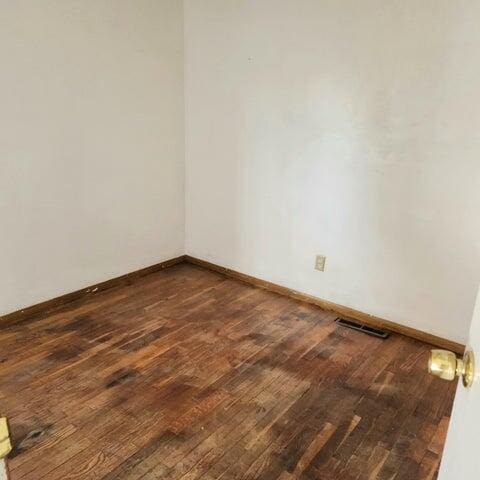 5678 Leona Ave, Muskegon, MI 49442 - unfurnished room with dark wood finished floors and baseboards