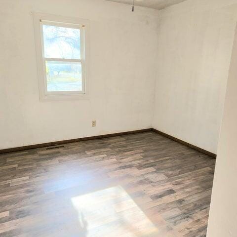 5678 Leona Ave, Muskegon, MI 49442 - empty room with wood finished floors and baseboards