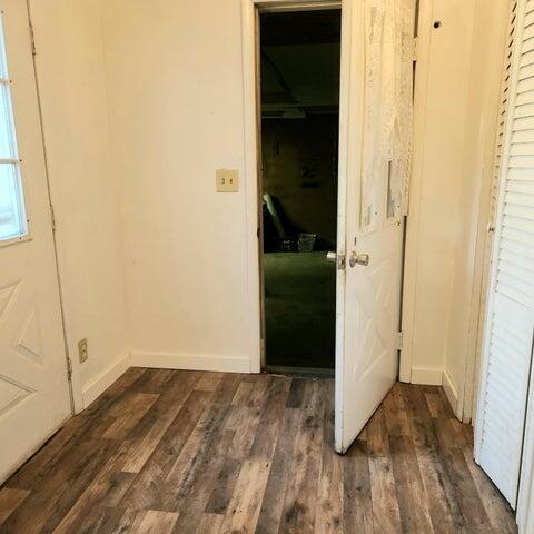 5678 Leona Ave, Muskegon, MI 49442 - hall with dark wood-style flooring and baseboards