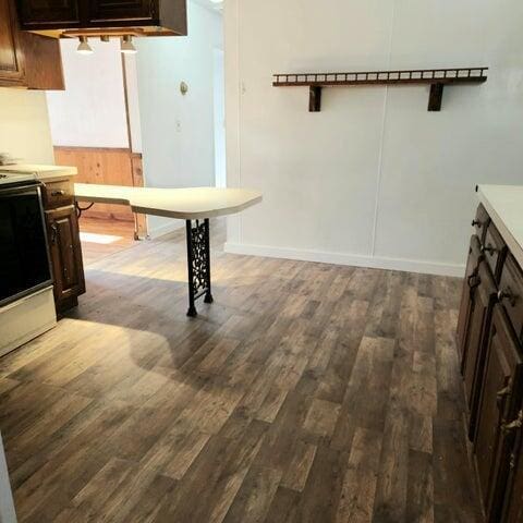 5678 Leona Ave, Muskegon, MI 49442 - kitchen featuring range, wood finished floors, dark brown cabinetry, and baseboards
