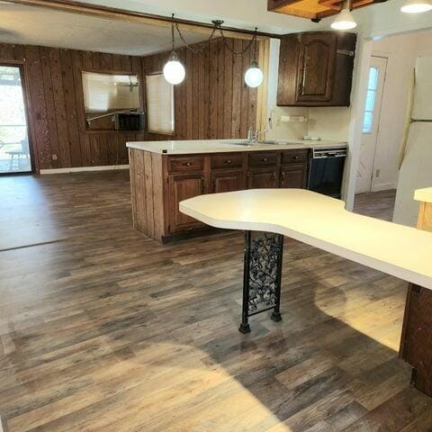 5678 Leona Ave, Muskegon, MI 49442 - kitchen featuring dishwasher, dark wood-style floors, light countertops, a sink, and freestanding refrigerator