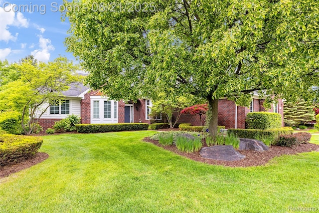 55161 Whitney Dr, Shelby Twp, MI 48315 - obstructed view of property featuring brick siding and a front yard