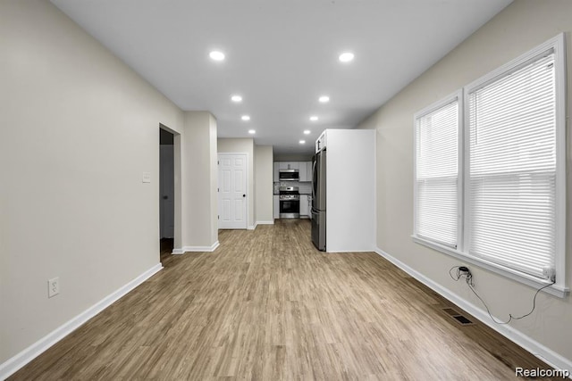 14850 Ilene St, Detroit, MI 48238 - unfurnished living room featuring light wood-style floors, baseboards, and recessed lighting
