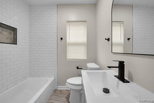 14850 Ilene St, Detroit, MI 48238 - full bathroom featuring toilet, vanity, baseboards, and tub / shower combination