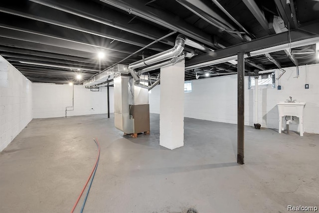 14850 Ilene St, Detroit, MI 48238 - below grade area with heating unit, a sink, and healthy amount of natural light