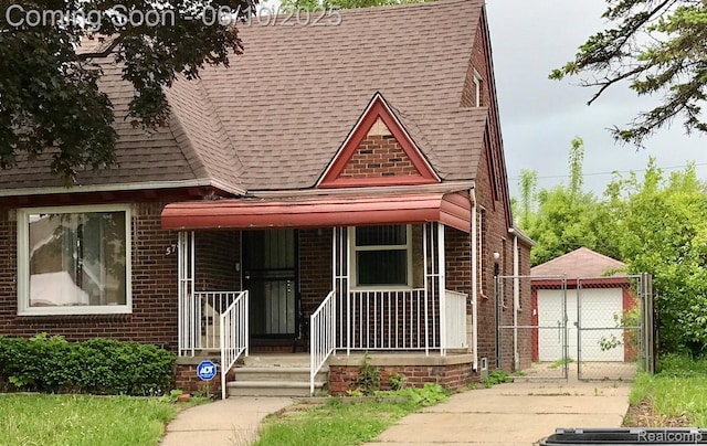5782 Haverhill St, Detroit, MI 48224 - view of front of house featuring roof with shingles, brick siding, a porch, and a gate