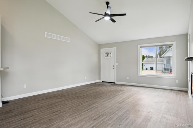 1759 2nd St, Taylor, MI 48192 - unfurnished living room featuring high vaulted ceiling, a ceiling fan, wood finished floors, and baseboards