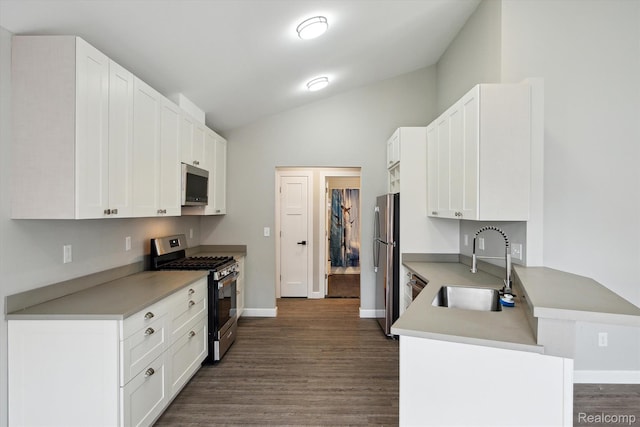 1759 2nd St, Taylor, MI 48192 - kitchen featuring stainless steel appliances, a sink, dark wood-type flooring, vaulted ceiling, and white cabinets