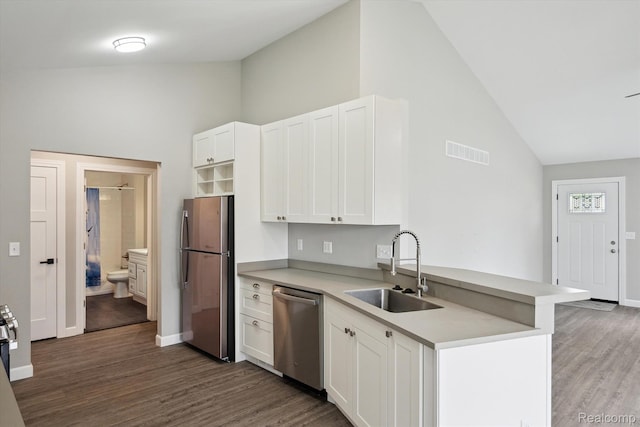 1759 2nd St, Taylor, MI 48192 - kitchen with appliances with stainless steel finishes, a sink, wood finished floors, high vaulted ceiling, and light countertops