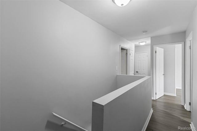 18625 Carrie St, Detroit, MI 48234 - corridor with an upstairs landing, baseboards, and dark wood finished floors