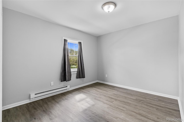 18625 Carrie St, Detroit, MI 48234 - empty room with a baseboard radiator, wood finished floors, and baseboards