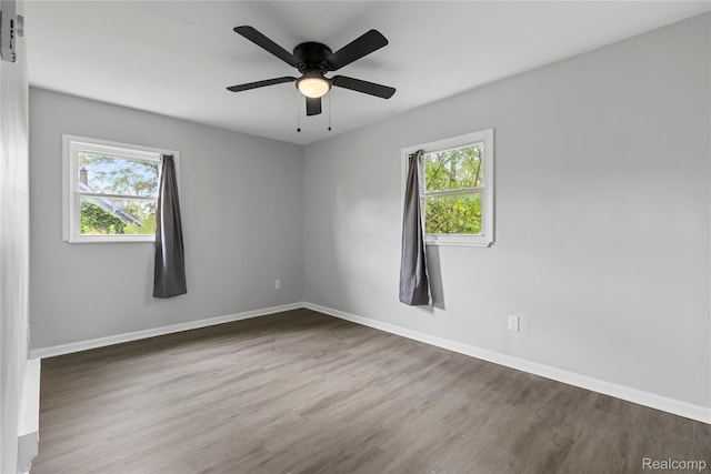18625 Carrie St, Detroit, MI 48234 - empty room with healthy amount of natural light, wood finished floors, baseboards, and a ceiling fan