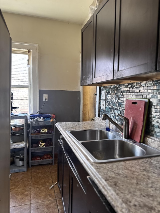 4649 Jonathon St, Dearborn, MI 48126 - kitchen featuring a sink, decorative backsplash, dark brown cabinets, and light countertops