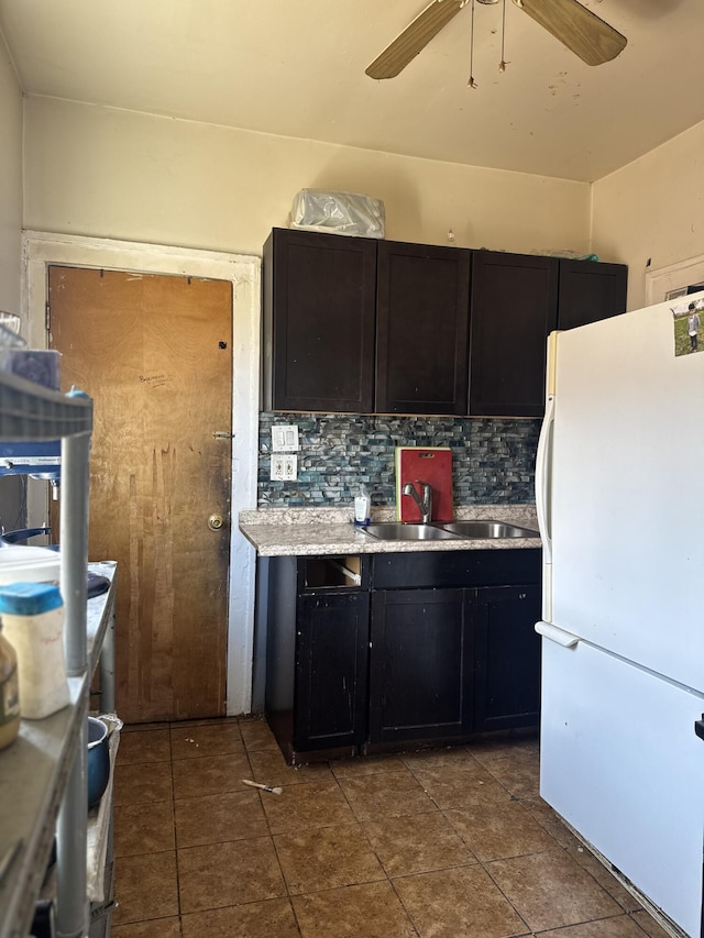 4649 Jonathon St, Dearborn, MI 48126 - kitchen featuring freestanding refrigerator, tasteful backsplash, a sink, ceiling fan, and light countertops