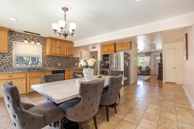2263 Lawnel Ave, Norton Shores, MI 49441 - dining space featuring a chandelier, light tile patterned floors, plenty of natural light, crown molding, and baseboards