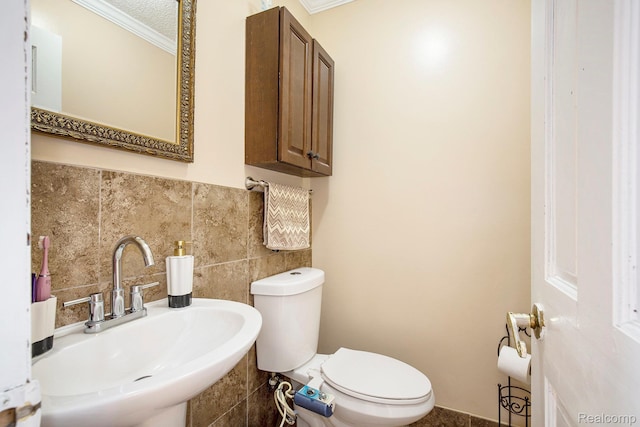 2263 Lawnel Ave, Norton Shores, MI 49441 - half bathroom with a sink, crown molding, toilet, tile walls, and decorative backsplash