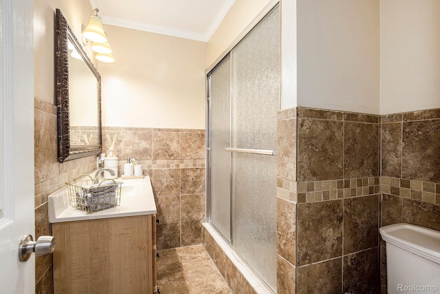 2263 Lawnel Ave, Norton Shores, MI 49441 - full bath featuring tile walls, a shower with shower door, toilet, ornamental molding, and vanity