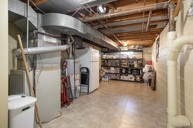 2263 Lawnel Ave, Norton Shores, MI 49441 - unfinished basement with gas water heater, freestanding refrigerator, and tile patterned floors