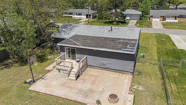 2263 Lawnel Ave, Norton Shores, MI 49441 - rear view of property featuring a patio and a shingled roof