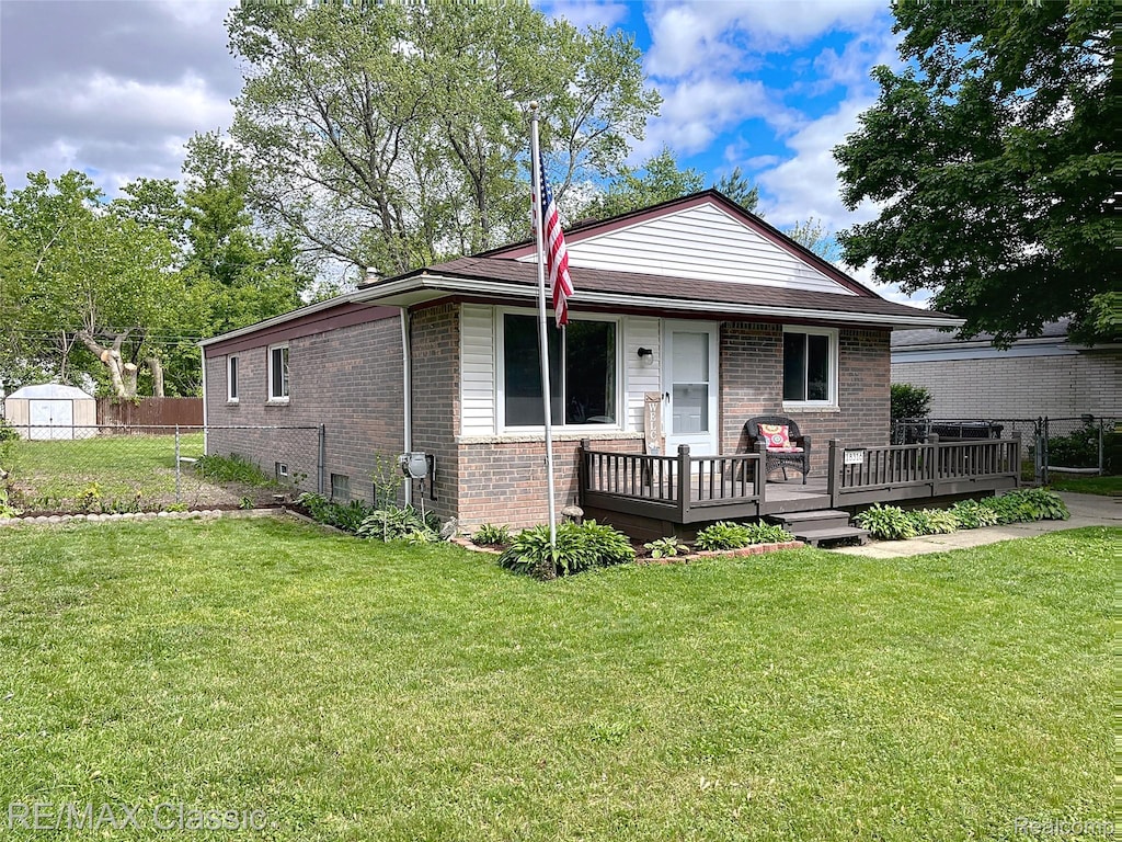 18316 Floral St, Livonia, MI 48152 - view of front facade with brick siding, a deck, and a storage unit