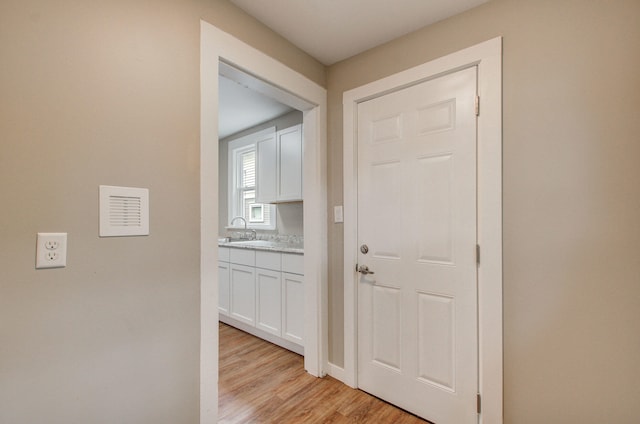 1118 Burr St, Jackson, MI 49201 - corridor with a sink and light wood-style flooring