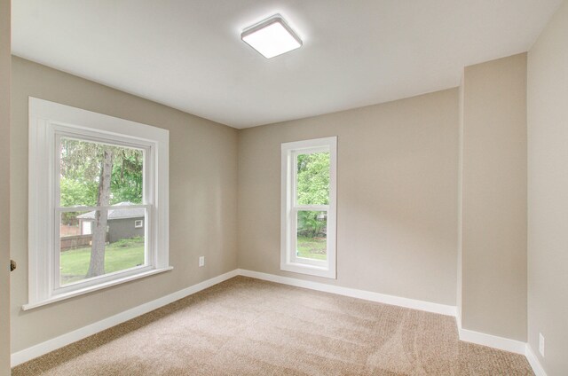 1118 Burr St, Jackson, MI 49201 - empty room featuring carpet flooring and baseboards