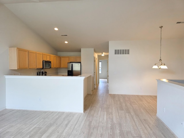 2936 Signature Blvd, Ann Arbor, MI 48103 - kitchen with stainless steel refrigerator with ice dispenser, light wood finished floors, light brown cabinetry, lofted ceiling, and light countertops