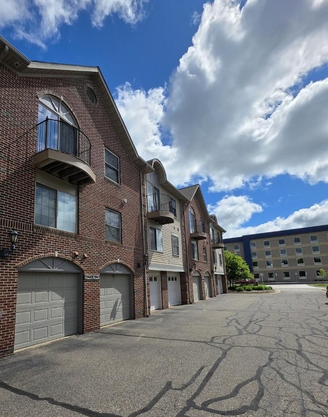 2936 Signature Blvd, Ann Arbor, MI 48103 - view of apartment building / complex featuring an attached garage and driveway
