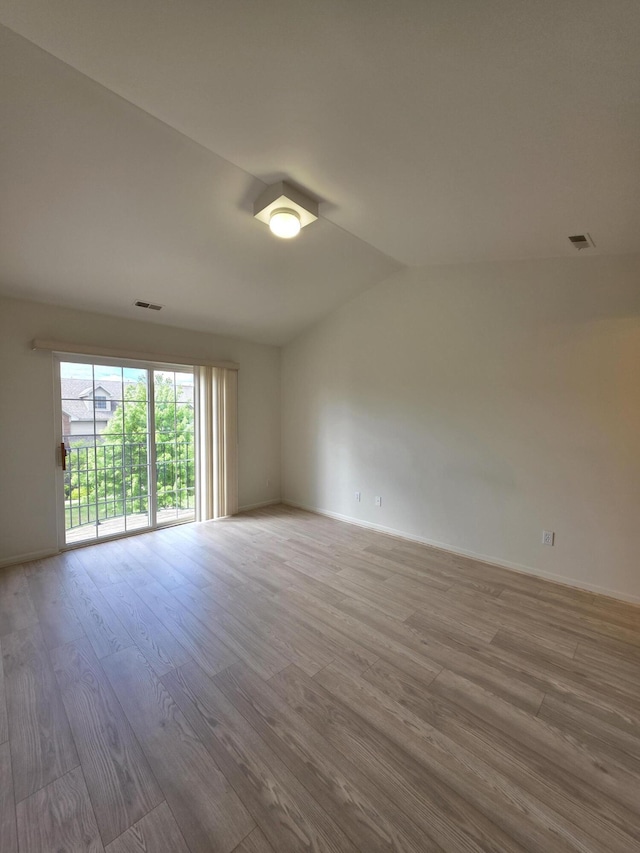 2936 Signature Blvd, Ann Arbor, MI 48103 - unfurnished room featuring wood finished floors, lofted ceiling, and baseboards