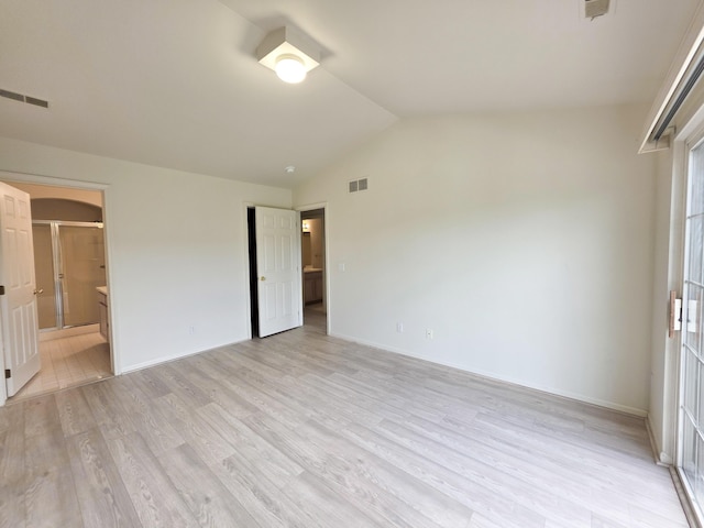 2936 Signature Blvd, Ann Arbor, MI 48103 - unfurnished bedroom with vaulted ceiling, light wood-style floors, baseboards, and ensuite bathroom