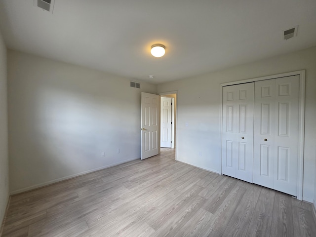 2936 Signature Blvd, Ann Arbor, MI 48103 - unfurnished bedroom with light wood finished floors, baseboards, and a closet
