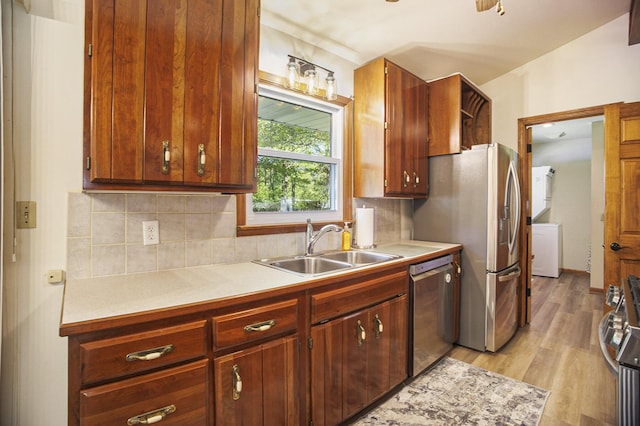 15035 155th Ave, Grand Haven, MI 49417 - kitchen with a sink, stainless steel appliances, light countertops, tasteful backsplash, and light wood-style flooring